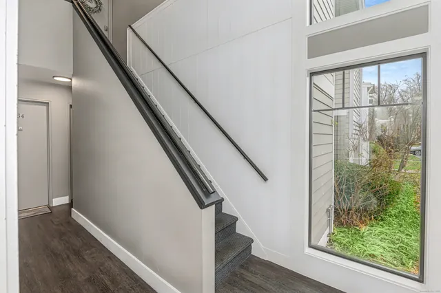 a view of entryway with wooden floor and door