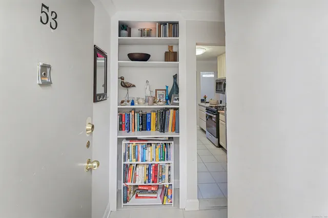 a view of a hardwood floor and a bookshelf with wooden floor