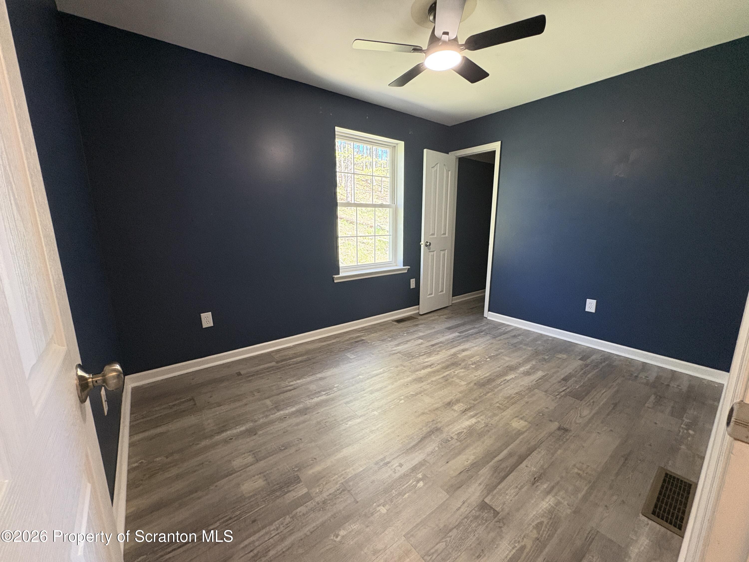 155 Baylor Road Nicholson, PA 18446 - Photo 43 of 53 wooden floor in an empty room with a window