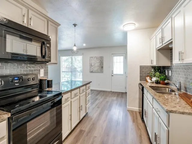 a kitchen with stainless steel appliances and wooden cabinets