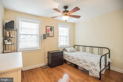 a living room with a bed furniture and a window
