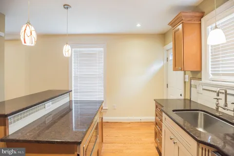 a kitchen with granite countertop a sink and a window