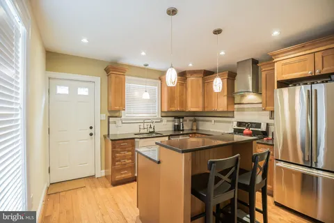 a kitchen with a sink appliances and cabinets