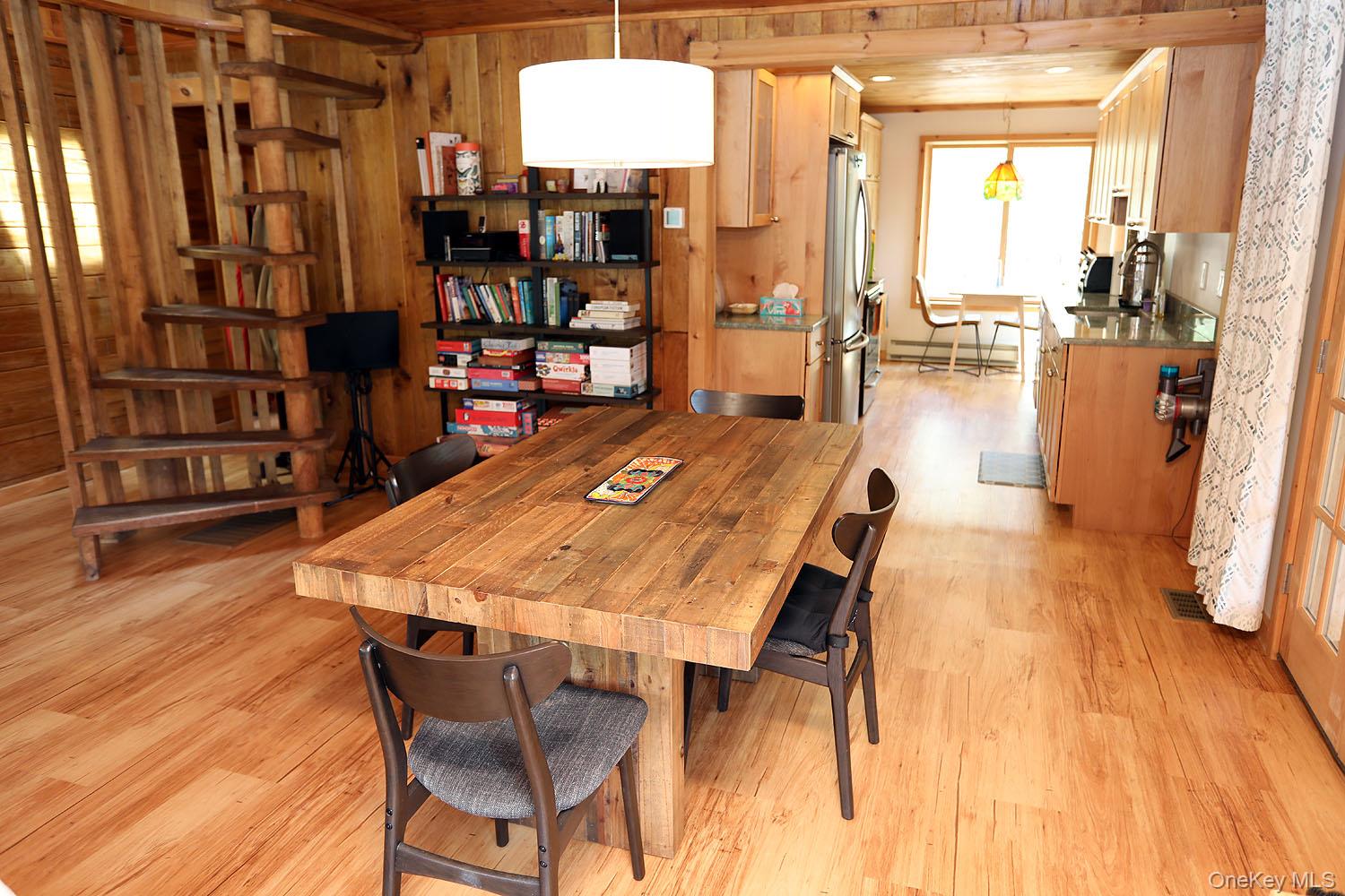 5120 Peas Eddy Road Hancock, NY 13783 - Photo 13 of 37 a dining room with stainless steel appliances lots of furniture and wooden floors
