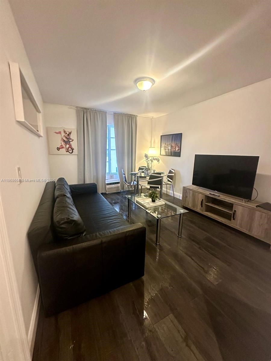 3030 Collins Avenue, Unit 4F Miami Beach, FL 33140 - Photo 11 of 24 a living room with furniture and a flat screen tv