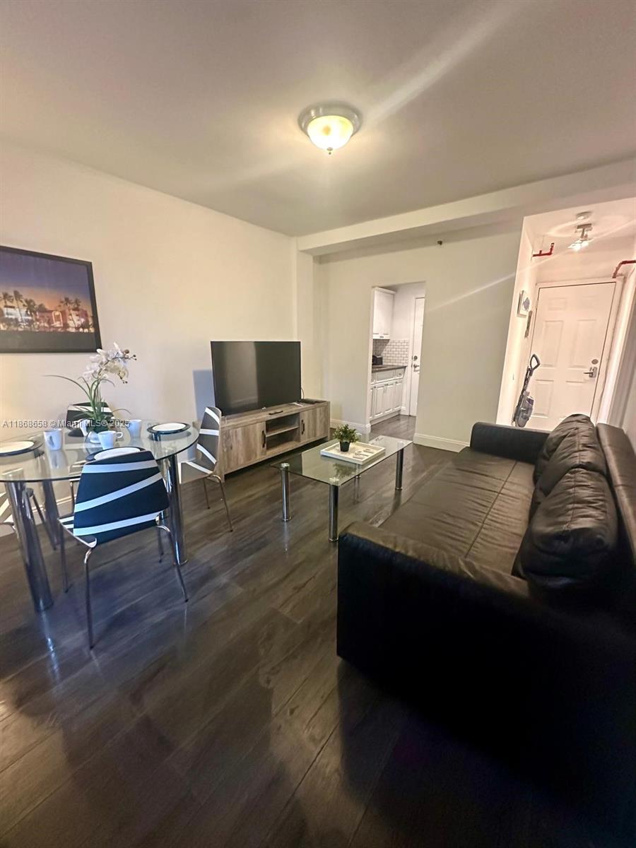 3030 Collins Avenue, Unit 4F Miami Beach, FL 33140 - Photo 12 of 24 a bedroom with a bed and a flat screen tv