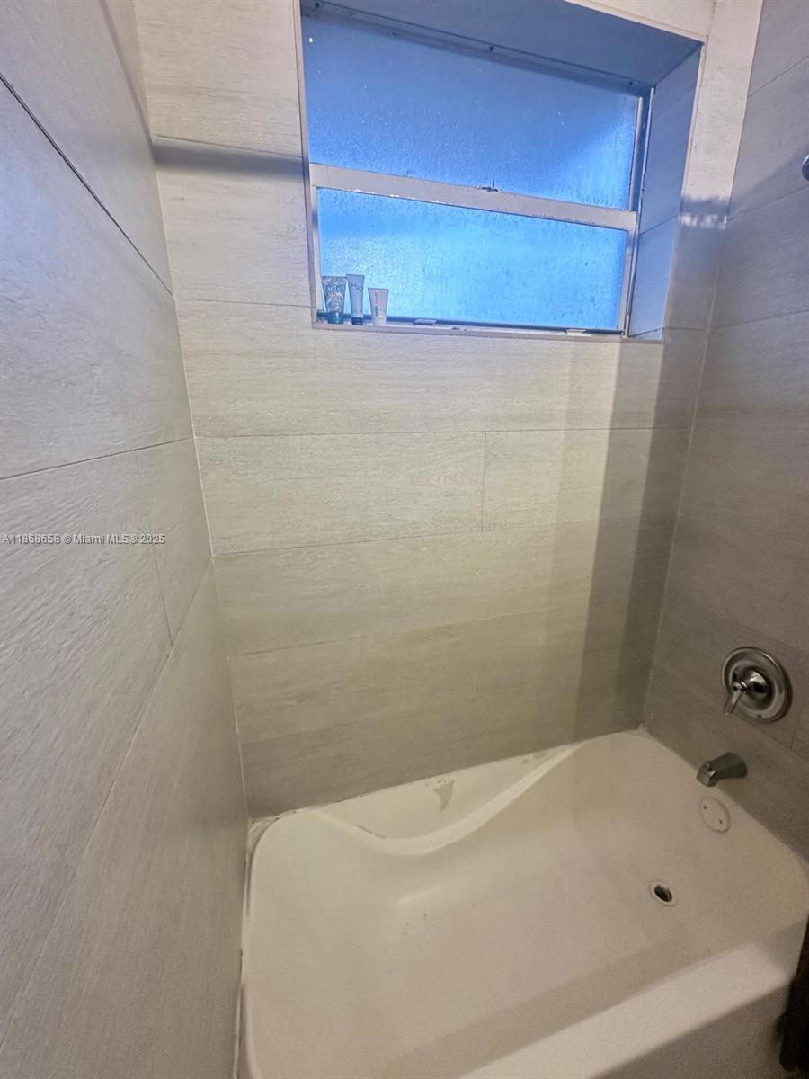 3030 Collins Avenue, Unit 4F Miami Beach, FL 33140 - Photo 21 of 24 a bathroom with a bathtub