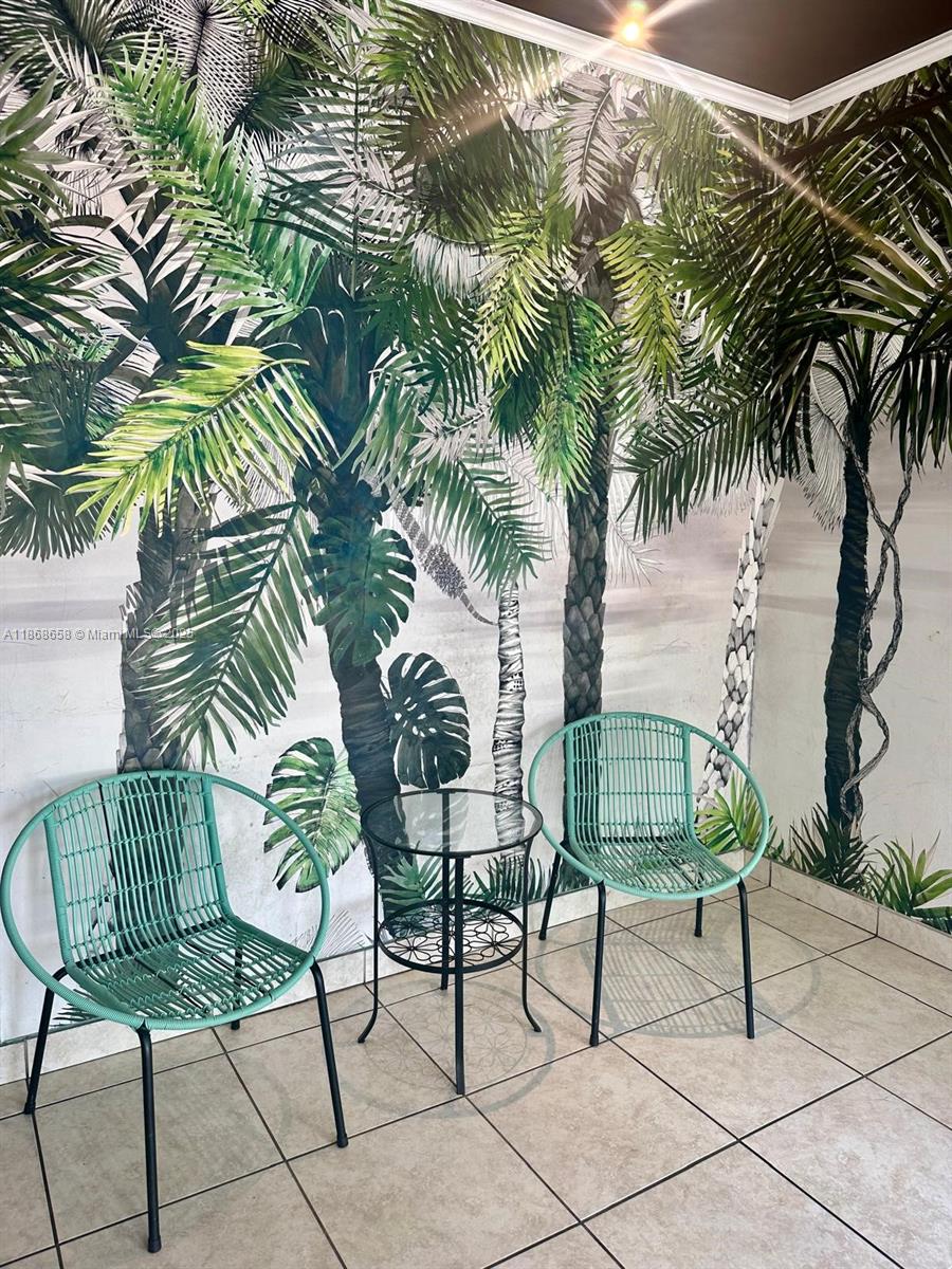 3030 Collins Avenue, Unit 4F Miami Beach, FL 33140 - Photo 23 of 24 a view of a chairs and table in a patio