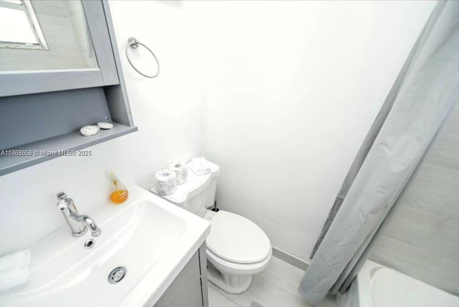 3030 Collins Avenue, Unit 4F Miami Beach, FL 33140 - Photo 24 of 24 a bathroom with a sink and a toilet