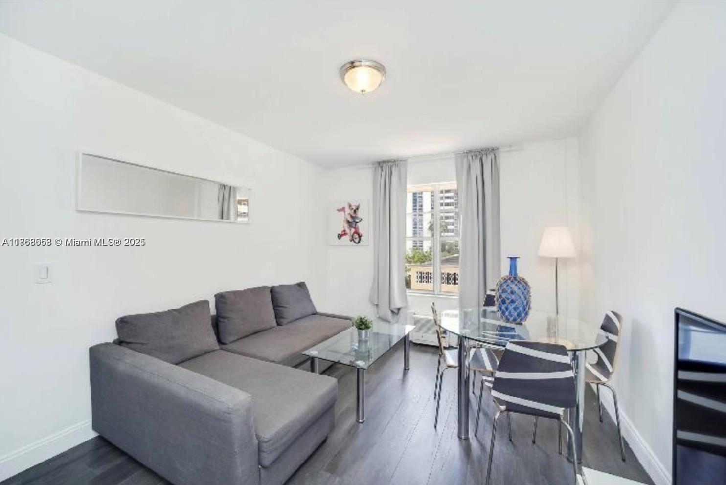 3030 Collins Avenue, Unit 4F Miami Beach, FL 33140 - Photo 3 of 24 a living room with furniture and wooden floor