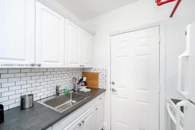 a kitchen with a sink and cabinets
