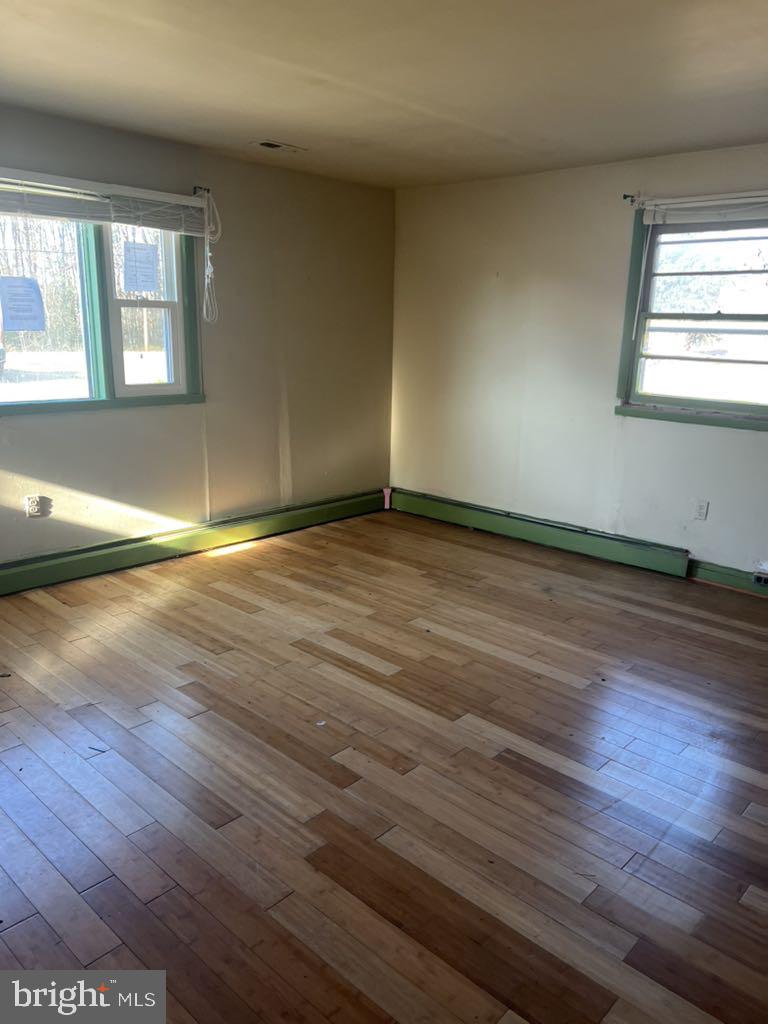 6640 Pomfret Road La Plata, MD 20646 - Photo 15 of 16 an empty room with wooden floor and windows