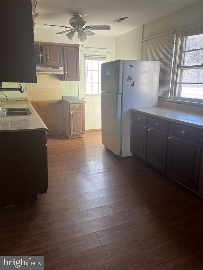 6640 Pomfret Road La Plata, MD 20646 - Photo 7 of 16 a kitchen with granite countertop a refrigerator and a sink