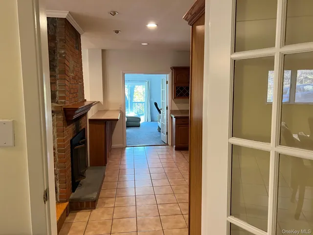 a hallway with a sink and a mirror