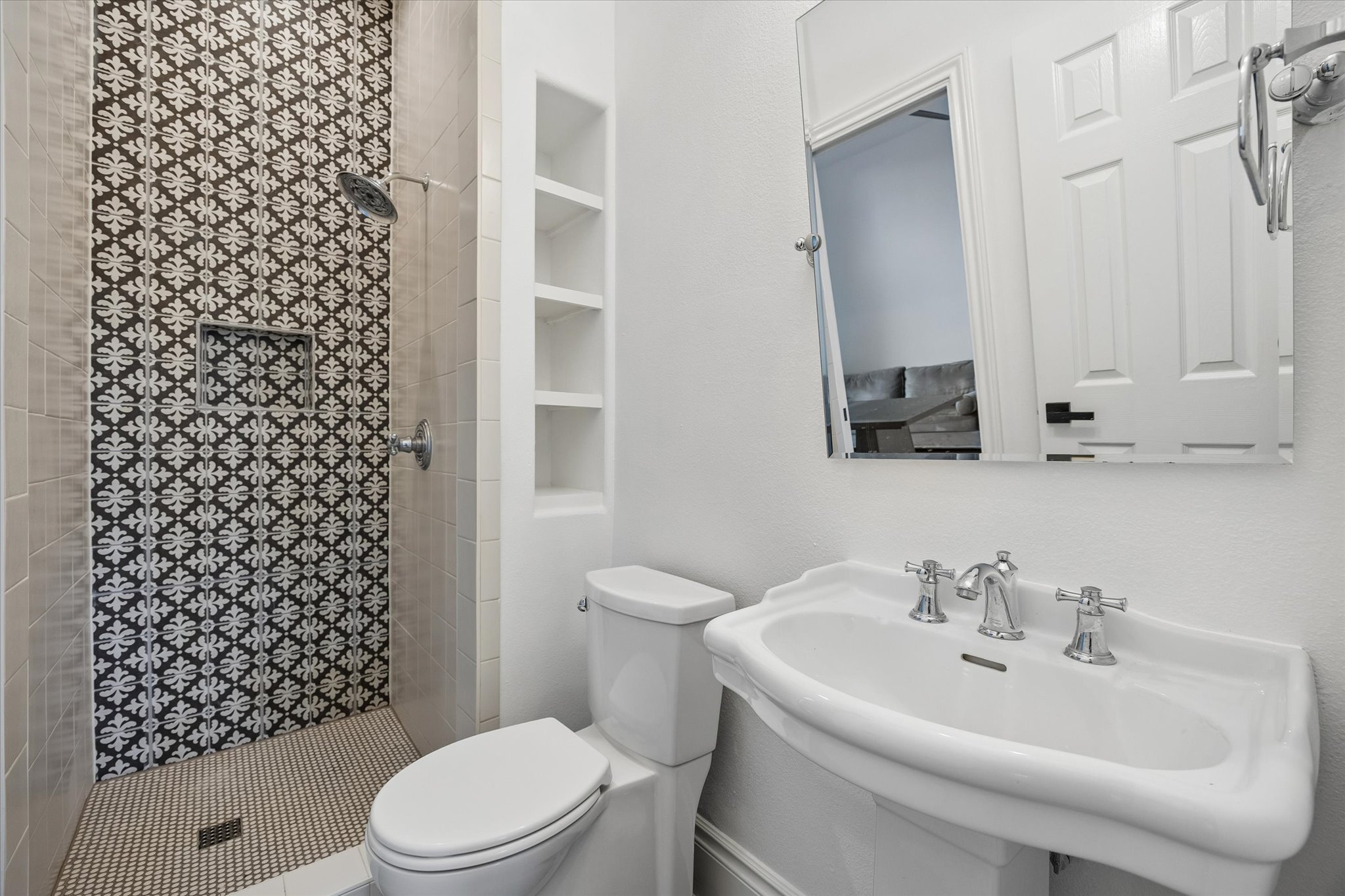 3719 Bee Creek Road Spicewood, TX 78669 - Photo 18 of 40 A well-appointed bathroom features a pedestal sink and an intricately tiled shower enclosure.