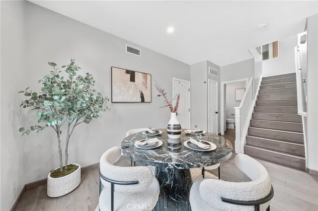 a view of a dining room with furniture window and wooden floor