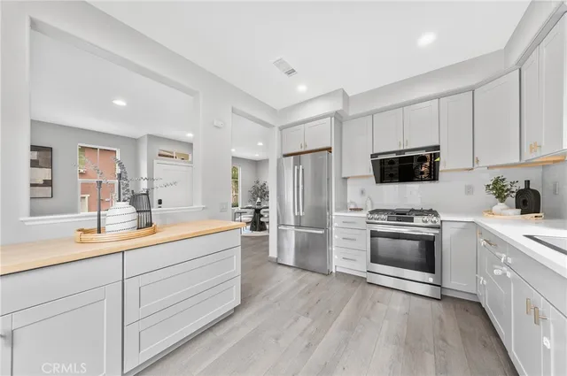a large kitchen with a sink dishwasher stove and refrigerator