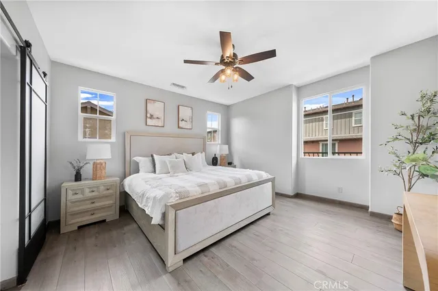 a bedroom with a large bed and a window