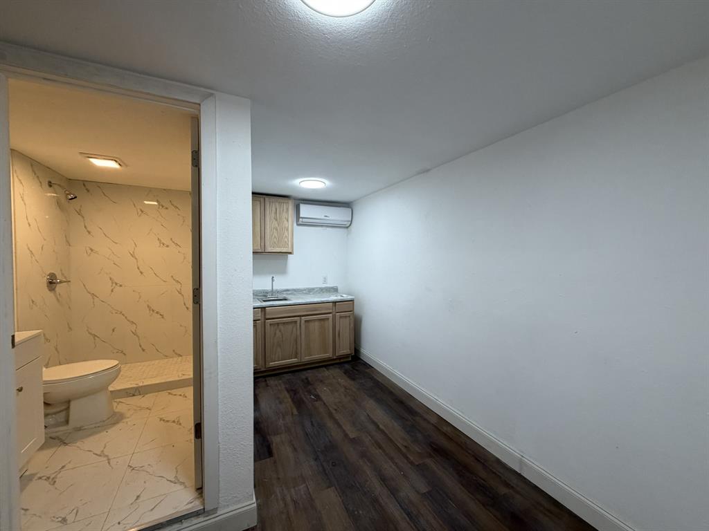 14131 Northwest 3rd Avenue, Unit C Miami, FL 33168 - Photo 2 of 7 a bathroom with a sink a toilet a mirror and shower