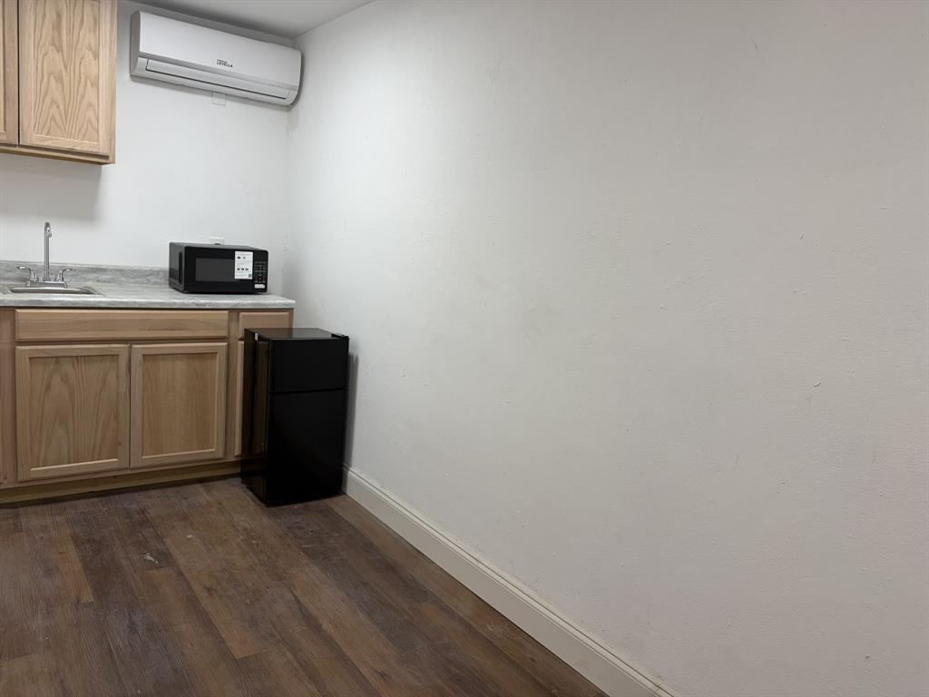 14131 Northwest 3rd Avenue, Unit C Miami, FL 33168 - Photo 3 of 7 a kitchen with a refrigerator and cabinets