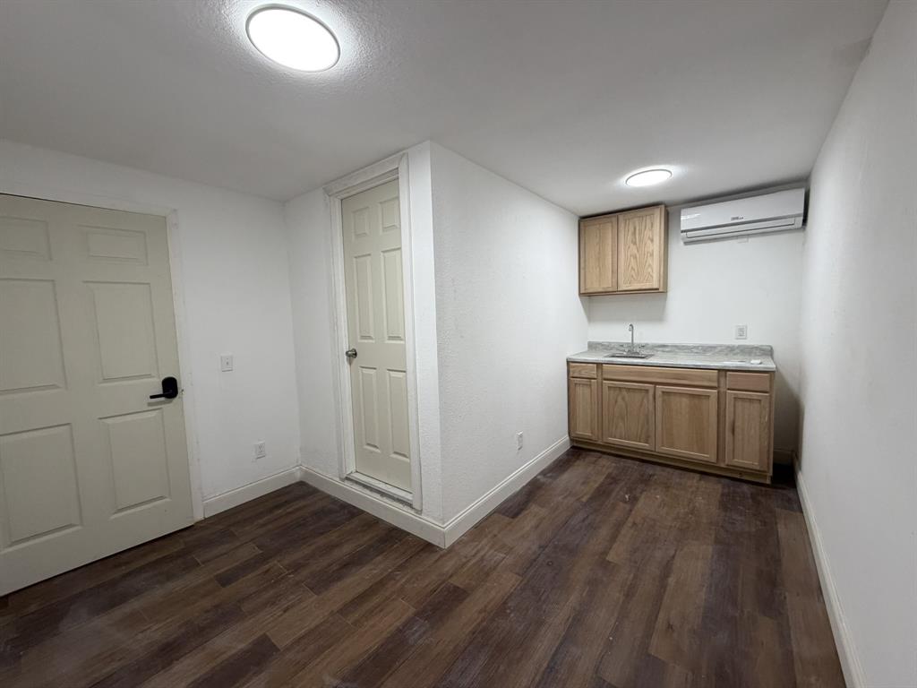 14131 Northwest 3rd Avenue, Unit C Miami, FL 33168 - Photo 4 of 7 a view of a kitchen with a sink wooden floor and a window