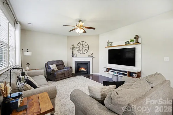a bedroom with furniture a flat screen tv and a fireplace
