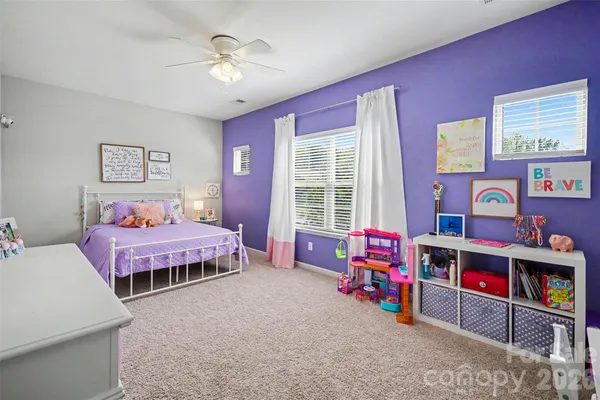 a bedroom room with furniture and a flat screen tv
