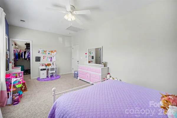a bedroom with bed and closet