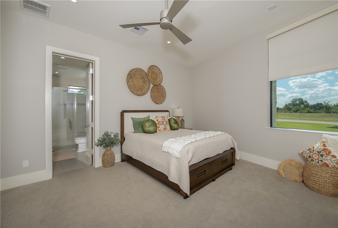 3320 Sycamore Trail Bryan, TX 77807 - Photo 29 of 48 Carpeted bedroom featuring baseboards, visible vents, ceiling fan, and ensuite bathroom