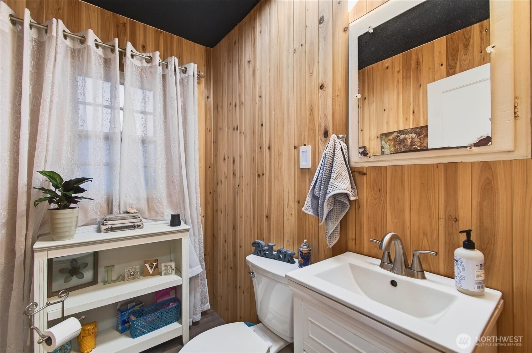 1210 8th Avenue Longview, WA 98632 - Photo 17 of 37 a bathroom with a sink a toilet and shower curtain