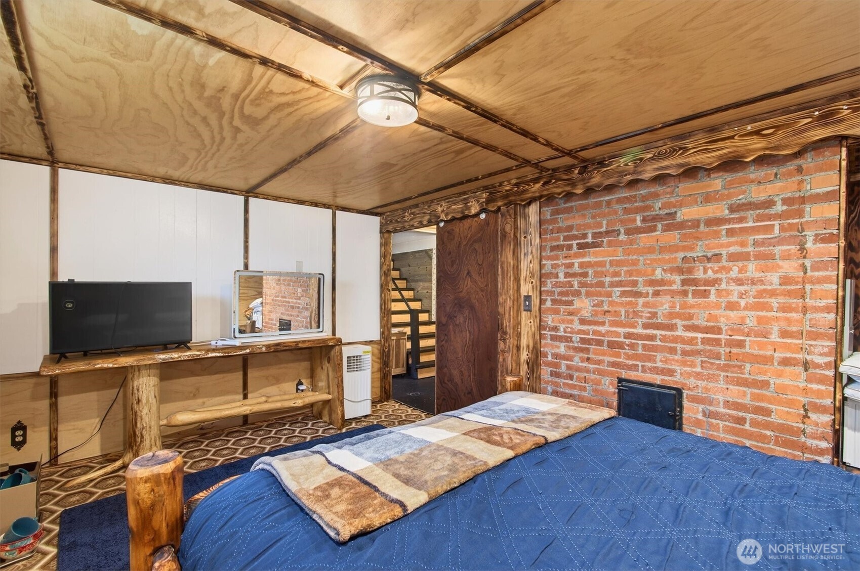 1210 8th Avenue Longview, WA 98632 - Photo 26 of 37 a bedroom with a bed and a flat screen tv