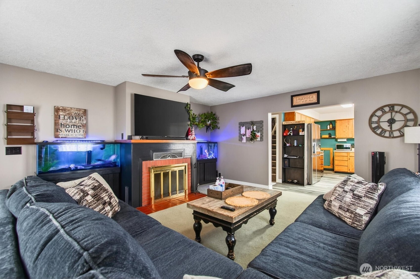 1210 8th Avenue Longview, WA 98632 - Photo 7 of 37 a living room with furniture a flat screen tv and a fireplace