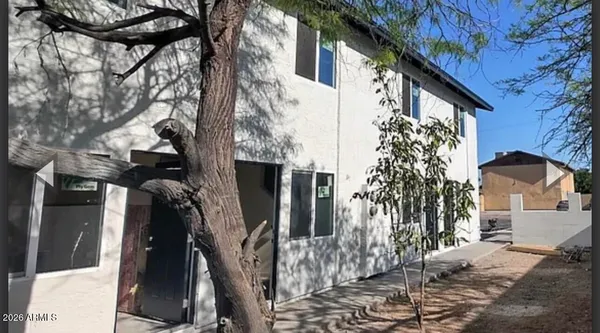 a view of a house with a tree