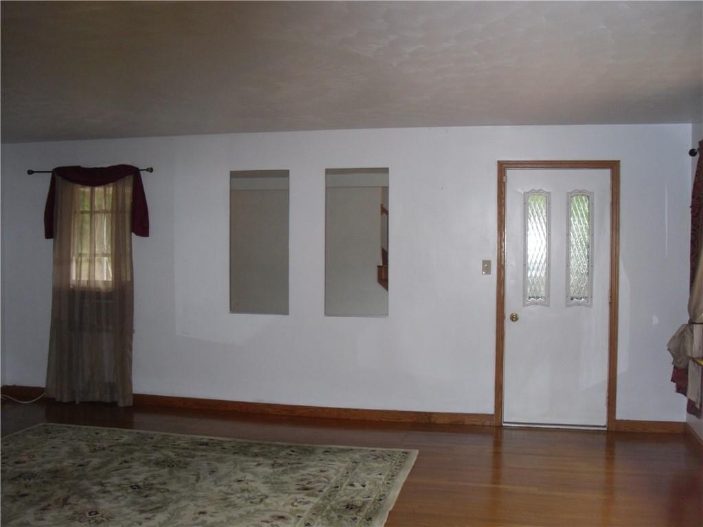 305 Whitehall Road Daisytown, PA 15427 - Photo 16 of 42 Living room with side door to covered large porch and fenced yard