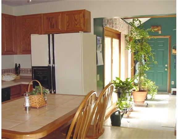 13 Allen Road Sturbridge, MA 01566 - Photo 8 of 16 a kitchen with a refrigerator a sink and a table