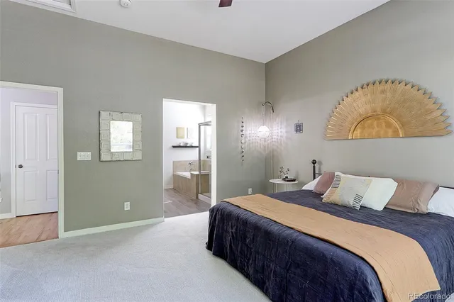 a bedroom with a bed and a painting on the wall