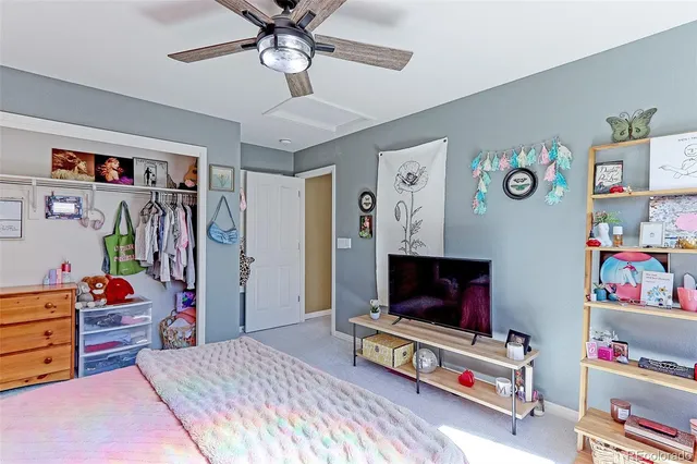 a bedroom with furniture and a flat screen tv