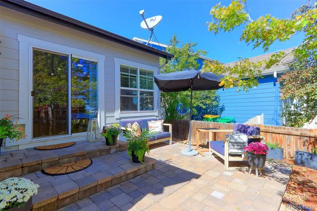 a view of a table and chairs in patio with potted plants