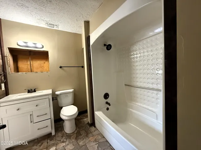 a bathroom with a toilet sink and bathtub