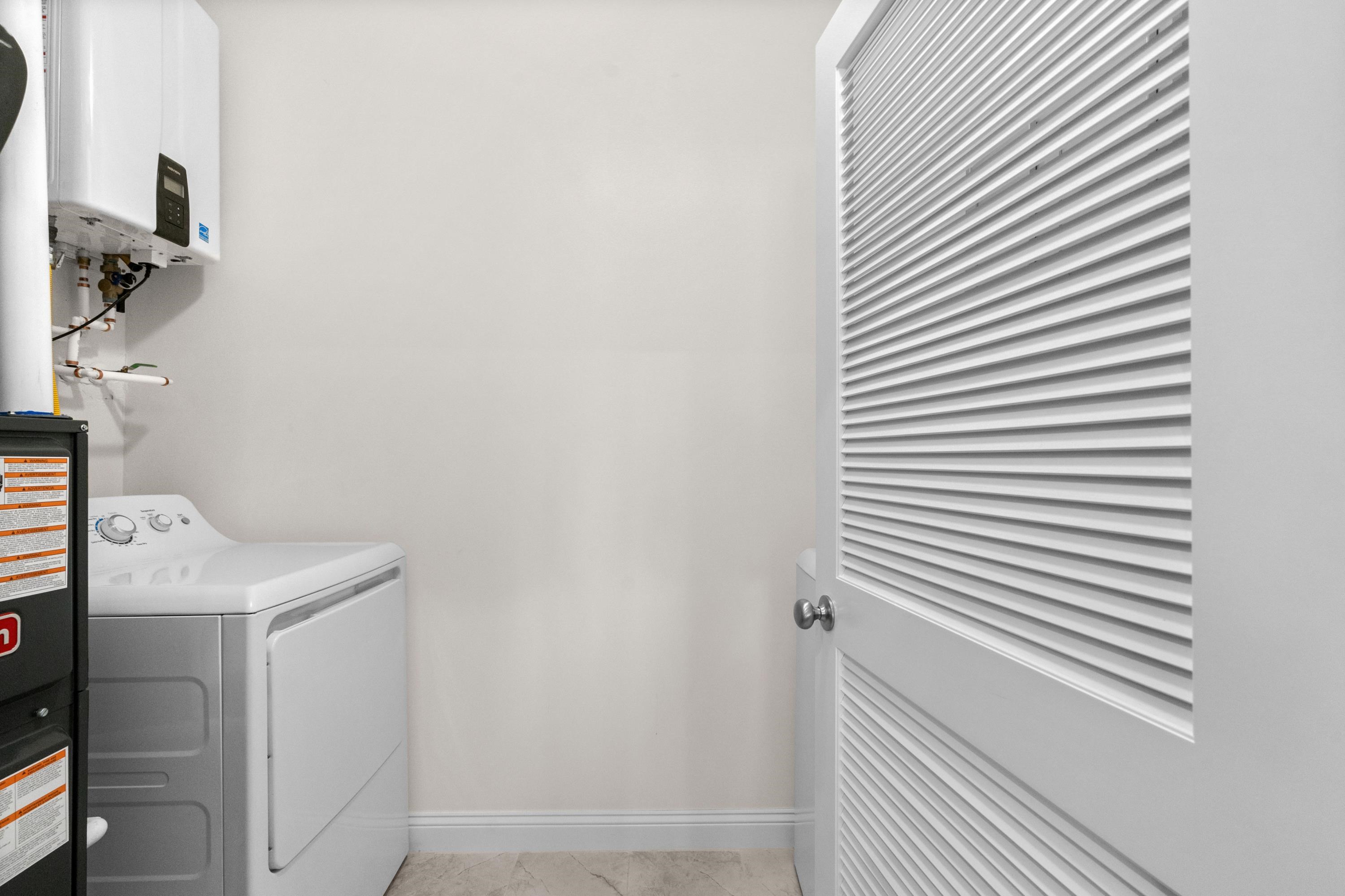948 Jackline Place, Unit 201 Murrells Inlet, SC 29576 - Photo 28 of 37 Laundry area with washer / clothes dryer and water heater