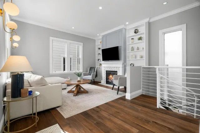 a living room with furniture a fireplace and a flat screen tv
