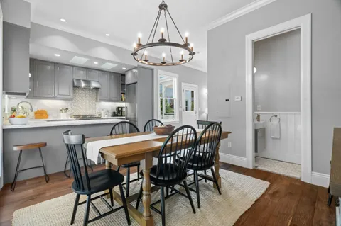 a view of a dining room with furniture window and wooden floor
