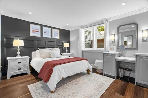 a bedroom with a bed and a view of living room