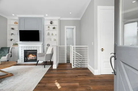 a living room with furniture a fireplace and a flat screen tv
