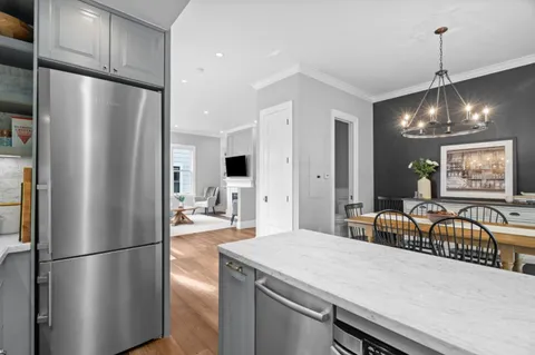 a kitchen with stainless steel appliances a refrigerator and a stove top oven