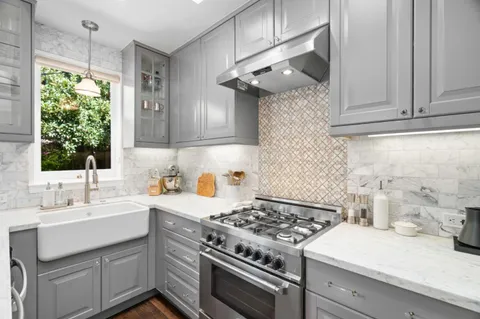 a kitchen with a sink stove and cabinets