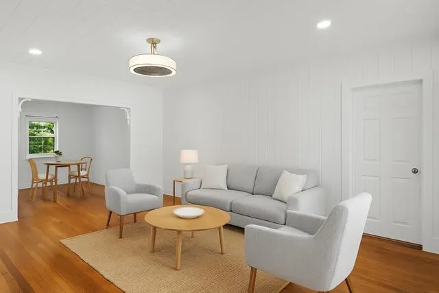 a living room with furniture a rug and a chandelier