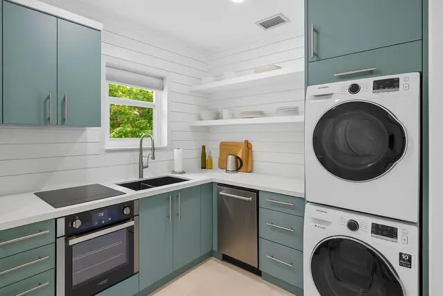 a kitchen with a sink a stove and cabinets