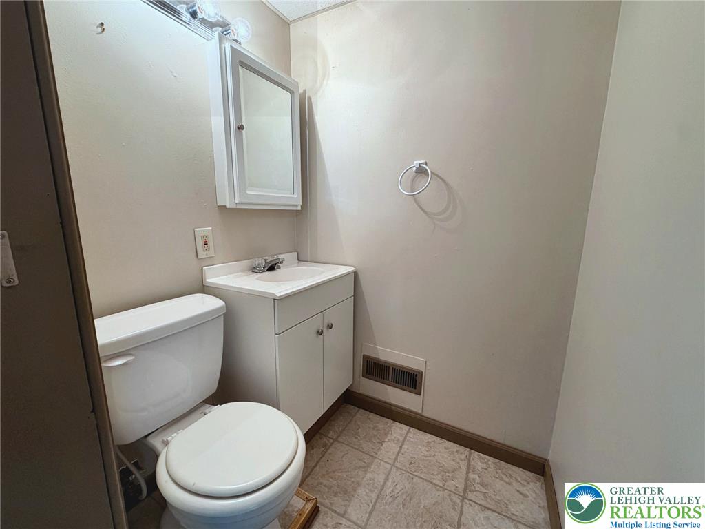 4995 Mountain Road Slatington, PA 18080 - Photo 21 of 30 Functional bathroom with a vanity and clean toilet, ready for daily routines.