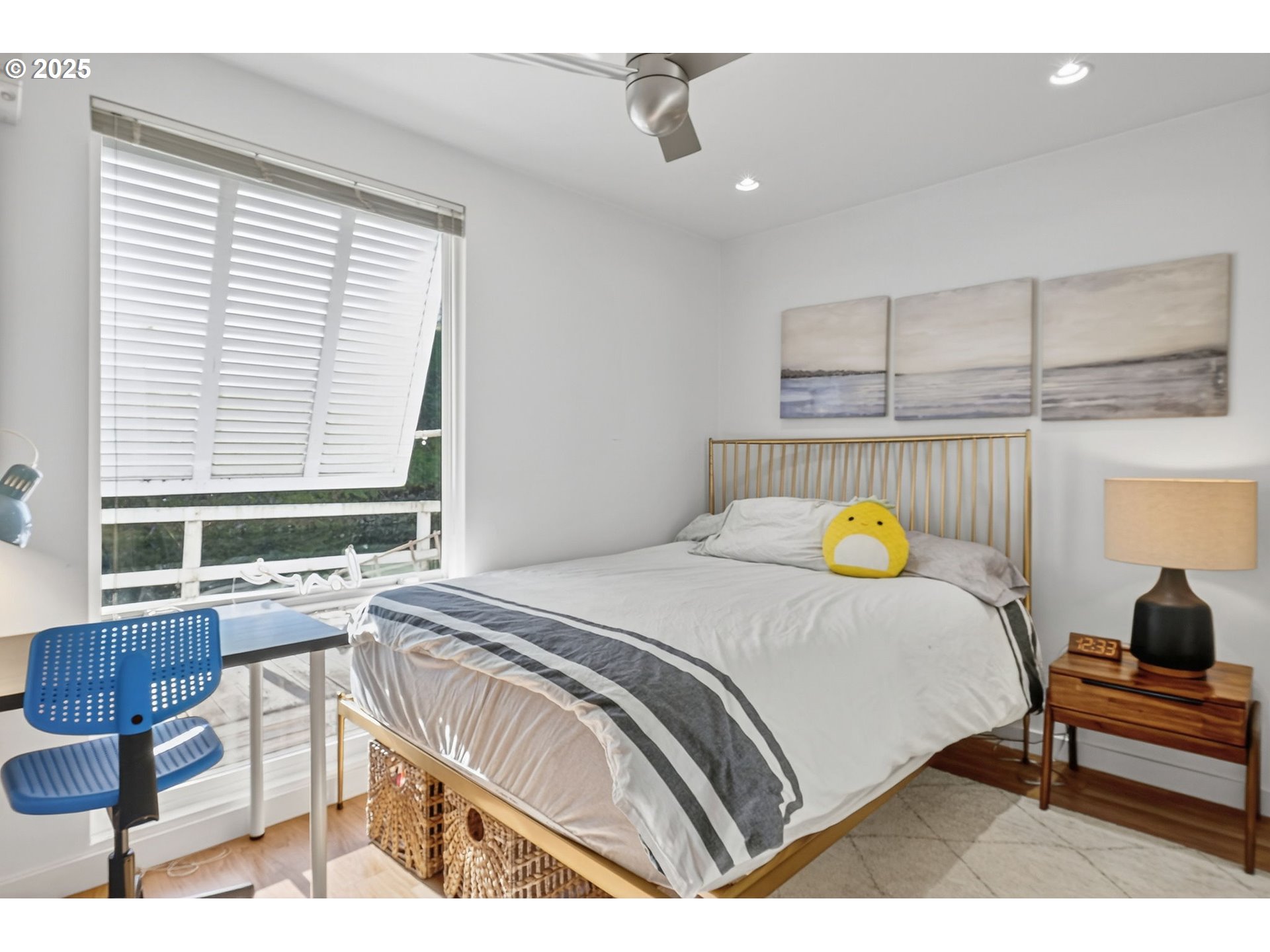 173 Northeast Bridgeton Road, Unit 13 Portland, OR 97211 - Photo 12 of 22 a bedroom with a bed and wooden floor